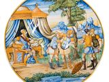 une assiette sur laquelle est représentée une peinture montrant des personnes