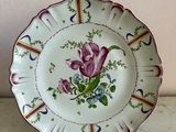 a plate with a flower on it sitting on a table