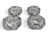 three clear glass knobs on a white surface with a white background