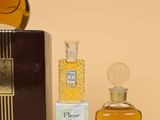 a bottle of perfume sitting next to a box of perfume