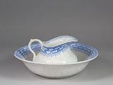 a white bowl with a blue and white pattern on it
