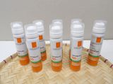 six bottles of sunscreen lotion sitting on top of a bamboo tray