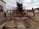an image of a flatbed truck with a machine in the back