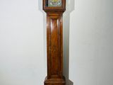 a tall wooden grandfather clock in the corner of a room