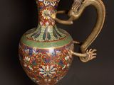 a vase with a dragon on it on a table