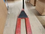 a forklift that is sitting on the floor in a warehouse