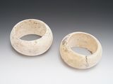 two white bowls sitting on top of a table next to each other