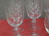 four empty wine glasses sitting on a red table cloth