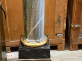 a vase that is sitting on a pedestal in a room