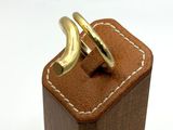 two gold rings sitting on top of a wooden box