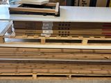 several stacks of wooden pallets stacked on top of each other in a warehouse