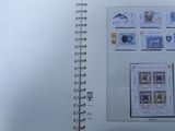 an open book with stamps on it sitting on a table