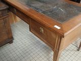 a wooden desk with a marble top in a room