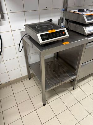 a kitchen with a stove and a counter with a stove top