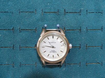 a watch that is sitting on a blue surface