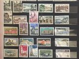 a framed picture of a collection of postage stamps on a wall