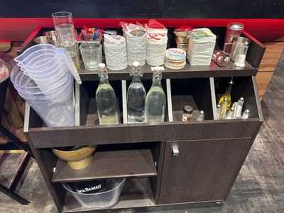 a wooden cart with many bottles and containers on it