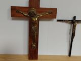 a cross, a crucif and a bunch of nuts on a table