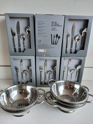three sets of silverware are sitting on a counter in front of a box