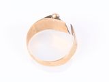 an image of a gold ring on a white surface