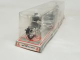 a box with a motorcycle inside of it on a white surface