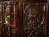 a wooden panel with carvings of a man and a woman on it