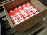 a cardboard box full of red and white soda cans