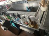 many bottles of alcohol and toothbrushes on the counter