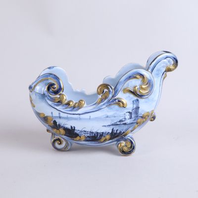 a blue and white bowl with gold decorations on it
