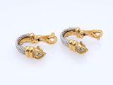 a pair of gold and silver earrings with diamonds