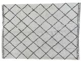 a white rug with a black and white design on it