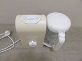 a small blender sitting on a table next to a charger