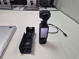 two remote controls sitting on a table next to a laptop
