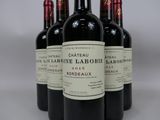 six bottles of red wine are lined up in a row