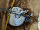 a close up of a guitar that is on a wooden table