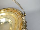 a silver plate with a spoon in it on a table