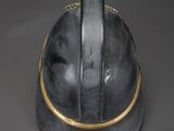 a close up of a helmet on a table with a black background