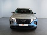 the front view of a silver car in a showroom
