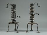 pair of metal sculptures of a snake and a snake sitting on a stool