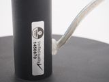 a close up of a black object with a white sticker on it