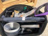 a black bag with tools inside of it on the ground