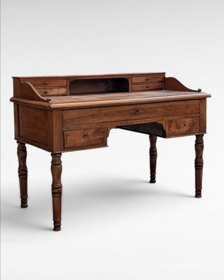 an old wooden desk with a drawer on top of it