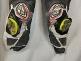 a close up of a pair of black and white motorcycle gloves