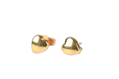 a pair of gold heart shaped stud earrings on a white background
