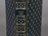 an old book with a blue cover and gold trim