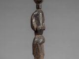a wooden statue of a woman holding a baby in her arms
