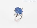 a close up of a ring with a blue stone on it