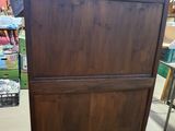 a wooden cabinet that is in the middle of a room
