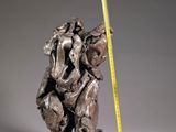 statue of a man holding a baseball bat next to a measuring tape