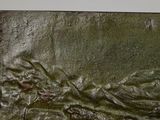 a close up of a metal plate with a bird on it